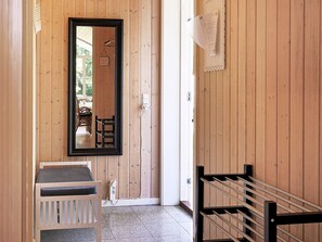 A wooden interior with a mirror, a white bench, and a staircase. - Holiday Home in Vejby (Vejby)
