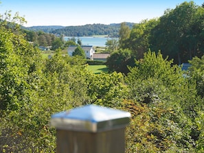 A view of a lake with houses in the background, surrounded by trees. - Holiday Home in Askeröarna (Hjaelteby)