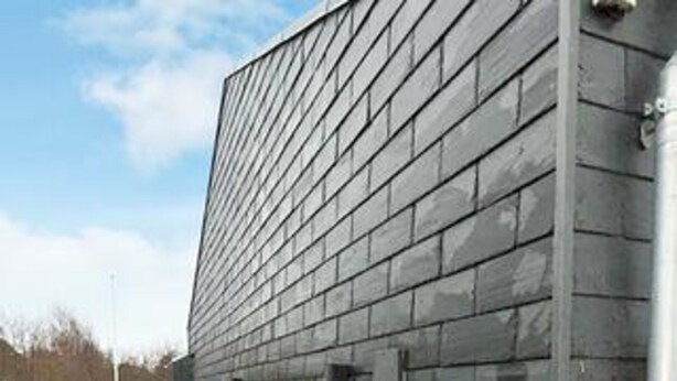 A building with a modern architectural style, featuring a flat facade with horizontal lines. - Holiday Home in Dannemare (Dannemare)