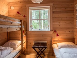 A cabin with bunk beds, a window, and a small table. - 4 Star Holiday Home in Norre Nebel (Norre Nebel)