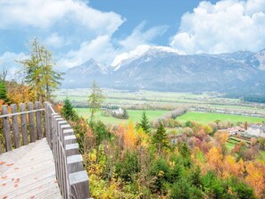 A wooden viewing platform overlooking a valley with autumn foliage and distant mountains. - Holiday House in Reith im Alpbachtal With Garden (Reith im Alpbachtal)
