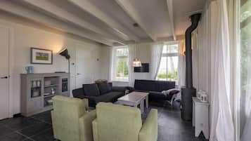 A living room with a fireplace, two sofas, a coffee table, and a cabinet.