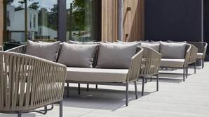 Outdoor seating with cushioned chairs and a sofa, arranged on a patio with a modern building in the background. - Comfy Bungalow near Bosland Nature Reserve (Hechtel-Eksel)