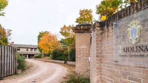 A brick wall with a coat of arms and the name "AIONA" visible. - Belvilla by OYO Aiolina (Sant'Angelo in Vado)