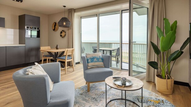 A modern apartment with a kitchen, dining area, and a balcony with a view. - Apartment in Egmond by the Beach (Egmond aan Zee)