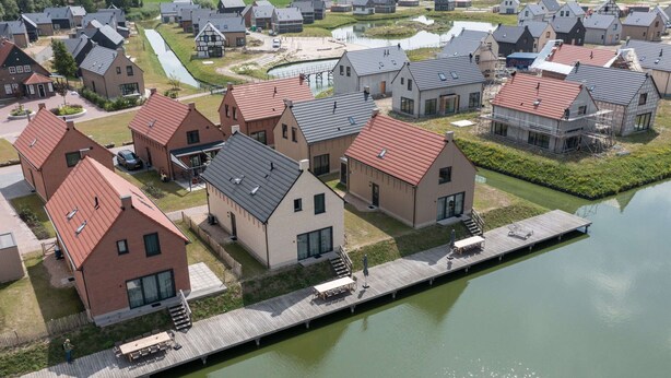 An aerial view of a residential area with houses, a dock, and a canal. - Villa by Lake Veere With Sauna (Wolphaartsdijk)