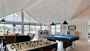A room with a foosball table, pool table, and bar area with seating. - Holiday Home in Nørre Nebel (Norre Nebel)
