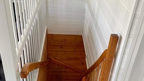 A wooden staircase with white walls and a white railing. - 6 Person Holiday Home in Bomlo (Bomlo)