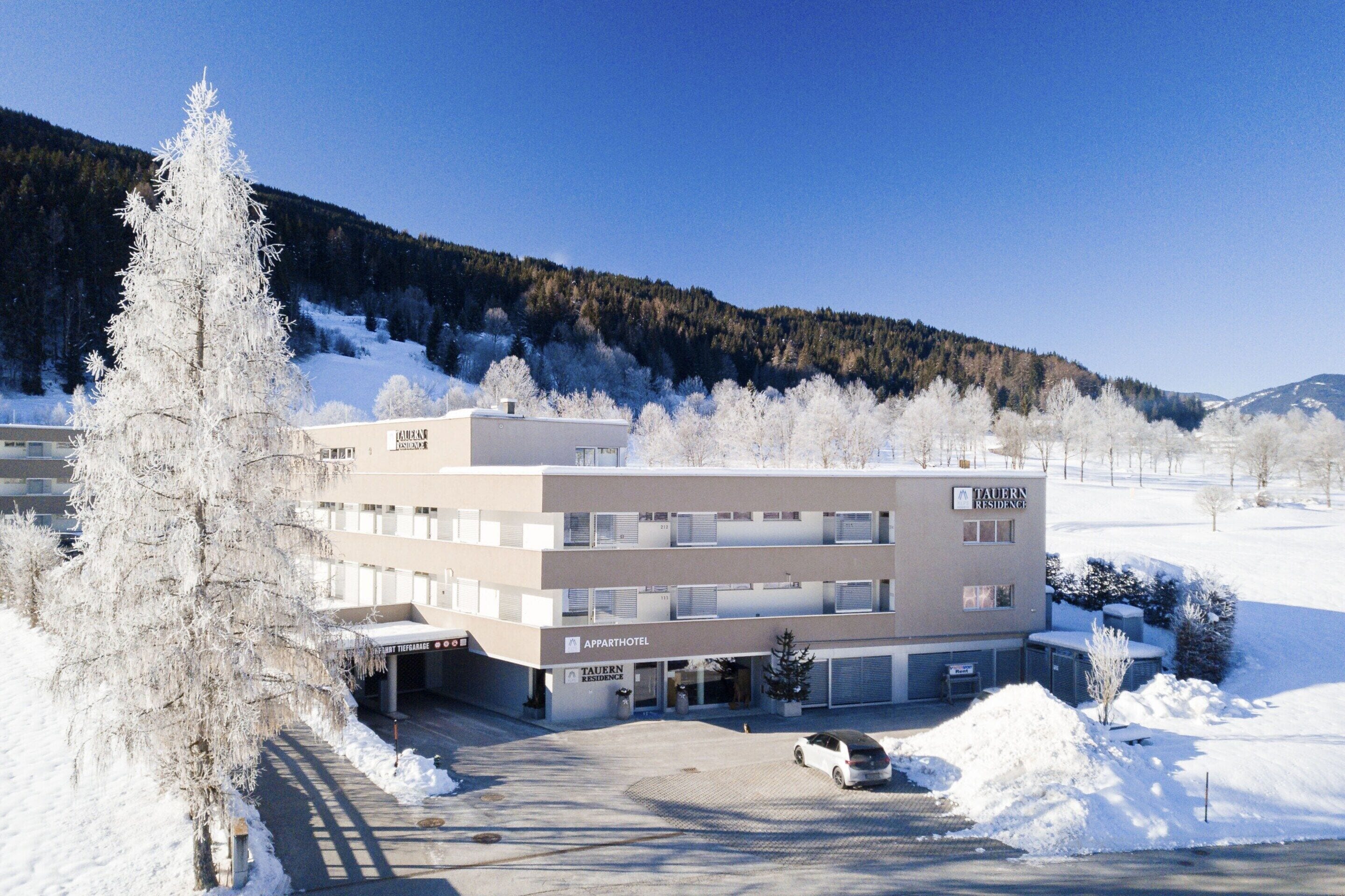 A multi-story building with a sign for 'Apparhotel' and 'Tavern Residence'.