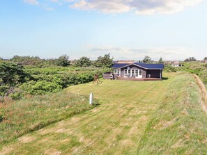 A single-story building with a dark roof and a large deck area. - 6 Person Holiday Home in Lokken (Lokken)