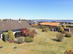 A residential area with houses, a vineyard, and a body of water in the background. - Holiday Home in Jægerspris (Jægerspris)