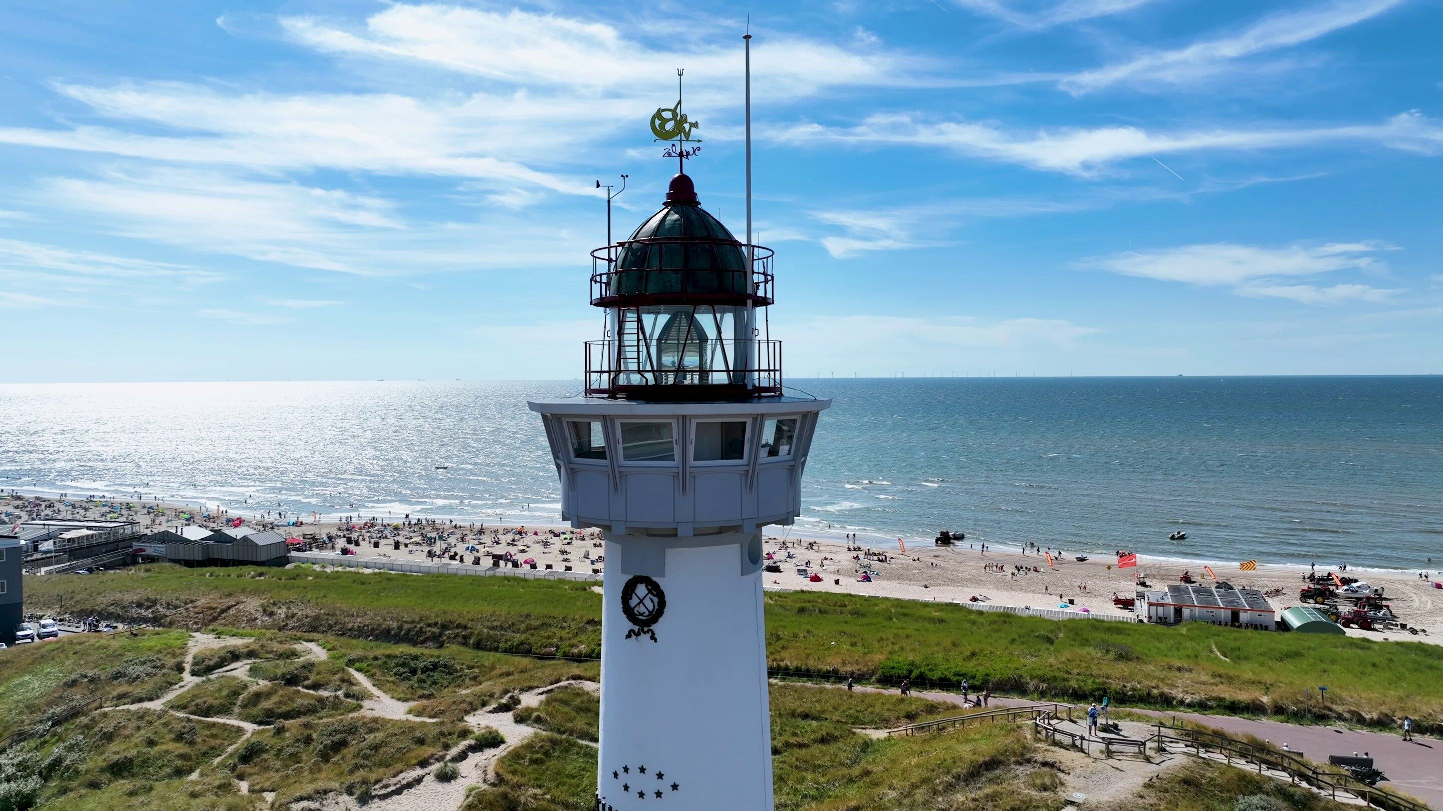 A lighthouse with a clear view of the beach and ocean.