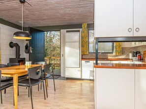 A modern kitchen with white cabinets, a wooden countertop, and a built-in oven. - 6 Person Holiday Home in Ans By (Farvang)