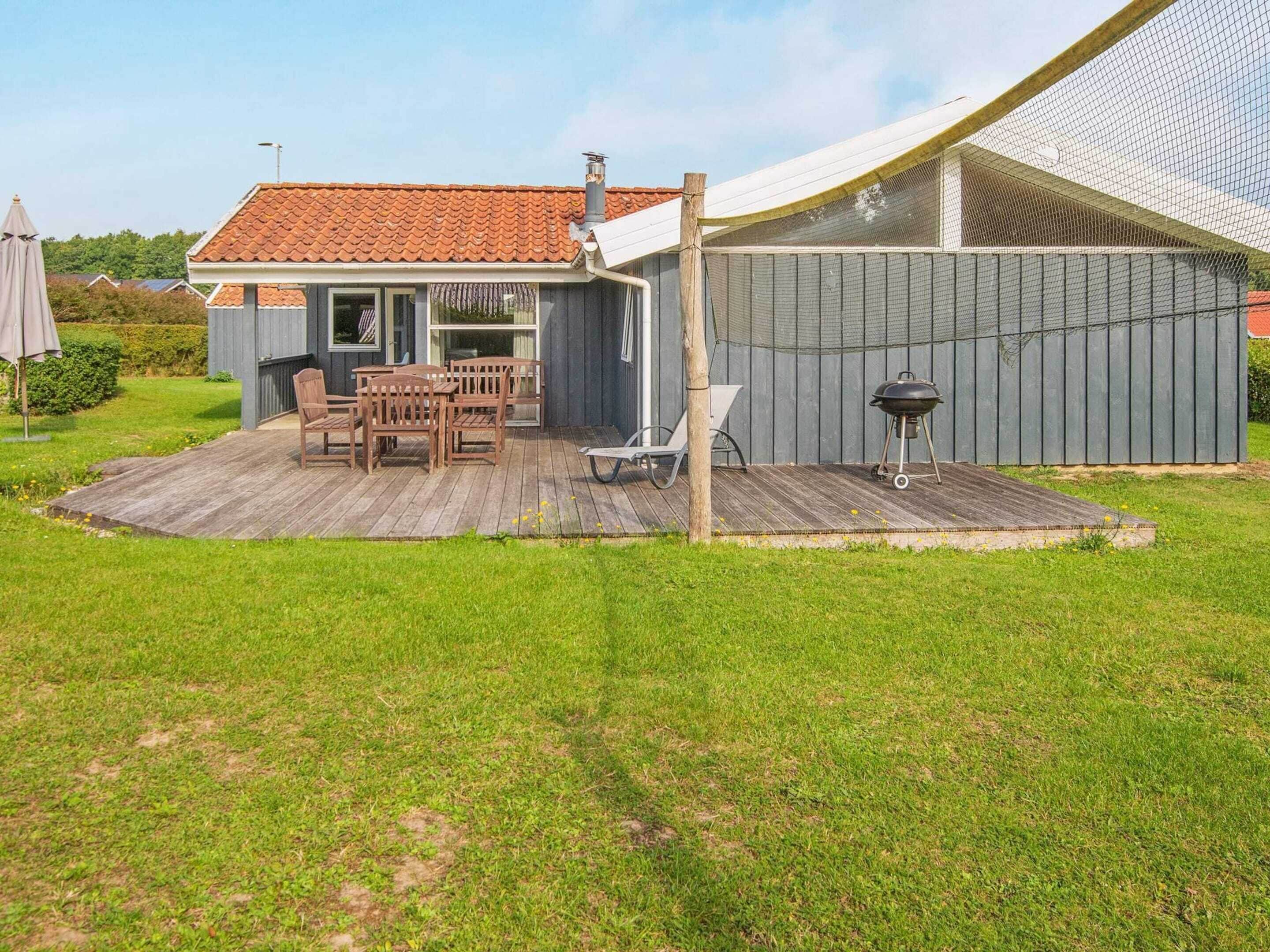 A house with a patio, a barbecue grill, and a covered outdoor area.