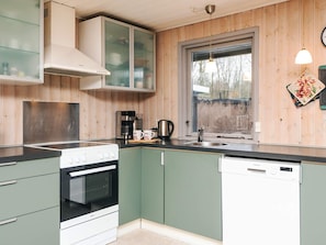 A kitchen with a stove, oven, dishwasher, and a coffee maker. - 6 Person Holiday Home in Toftlund (Toftlund)