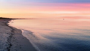 A beach with calm waters and a clear sky. - Holiday Home in VÃ¦ggerlÃ¸se (Vaeggerlose)