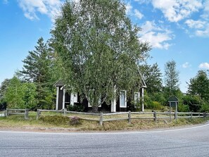 A historical building with a fenced area, surrounded by trees and a clear sky. - 5 Person Holiday Home in Linneryd/kronobergs Lan (Linneryd)