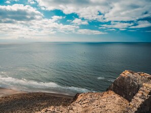 A coastal landscape with a rocky outcrop overlooking the sea. - Holiday Home in Løkken (Lokken)