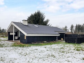A single-story building with a sloped roof, a chimney, and a small porch. - 4 Star Holiday Home in Lokken (Lokken)