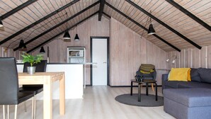 A loft-style room with a dining area, kitchenette, and seating area. - 4 Person Holiday Home in Hvide Sande (Hvide Sande)