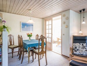 A dining area with a table, chairs, and a view of the outside.