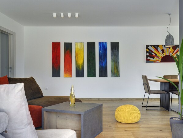 A modern living room with a sofa, a coffee table, and a dining area with chairs. - Comfortable, Stylish, Detached Villa With Garden, Private Pool, Near the Beach (Medulin)