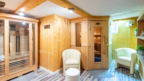 A sauna room with wooden walls, a bench, and a bench seat.