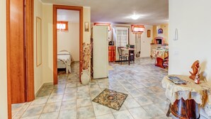Amplia sala de estar con mesa de comedor, cocina y un dormitorio con cama y armario.