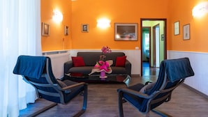A room with two black chairs, a grey sofa, and a pink vase on a glass table. - Villa by Lake Idro With Panoramic Views (Idro)