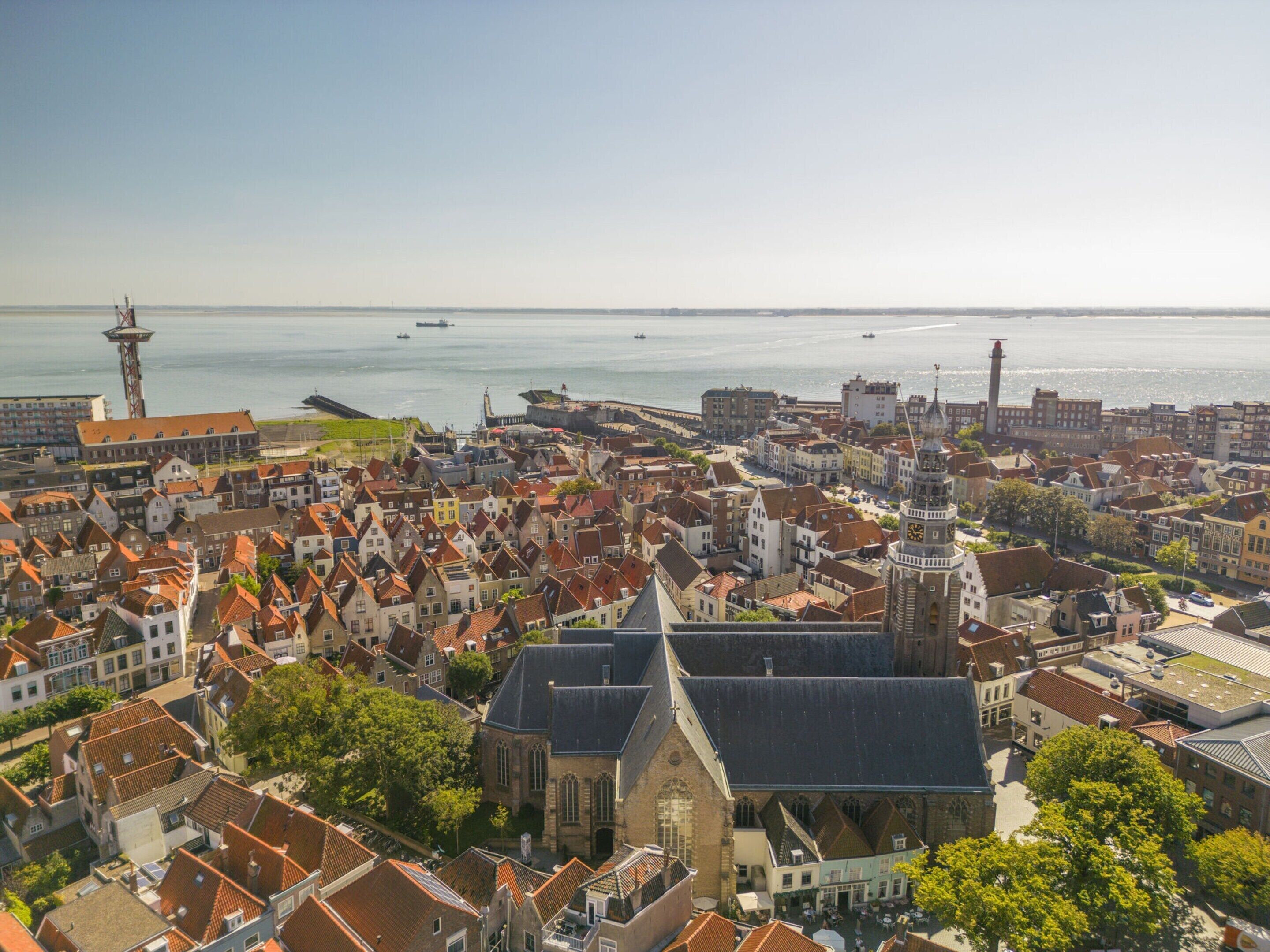 A historic town with a prominent church and a lighthouse.