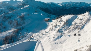 A snow-covered mountain landscape with a ski lift and a lodge. - Cozy Holiday Apartment Close to the Slopes (Kleinarl)