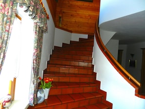 A staircase with red brick steps leading to a wooden landing. - Cozy Holiday Apartment Close to the Slopes (Kleinarl)