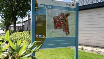Schild mit einer Karte und Text für EuroParcs Resort Kaatsheuvel, das Annehmlichkeiten wie einen Spielplatz, Golf und Parkplätze anzeigt.