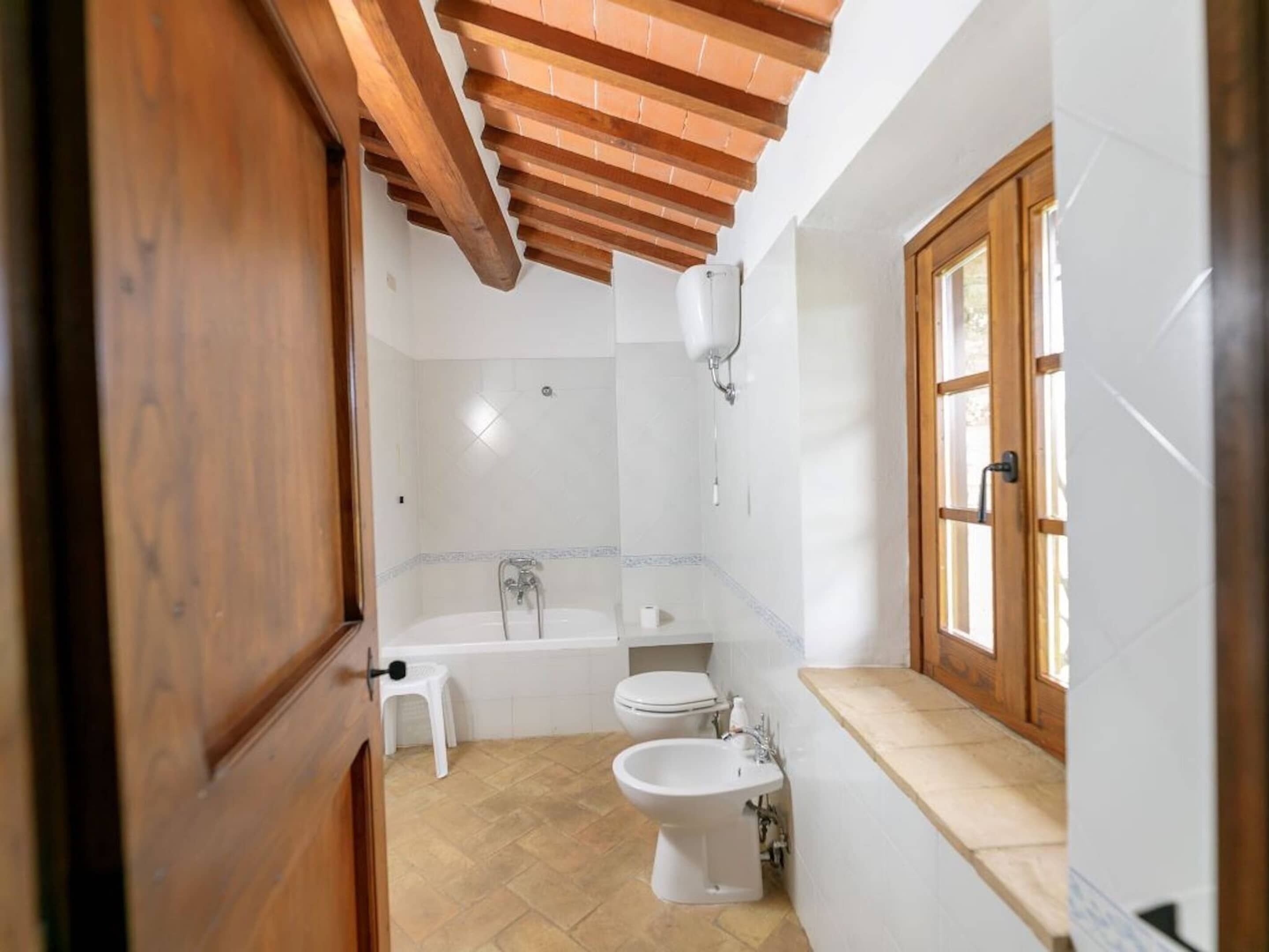 A bathroom with a bathtub, toilet, and sink.