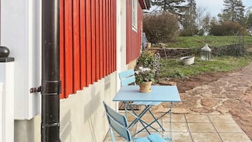 A red and white building with a blue table and chairs outside.