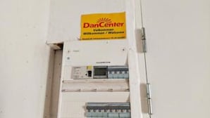 A DanCenter sign above an electrical panel.