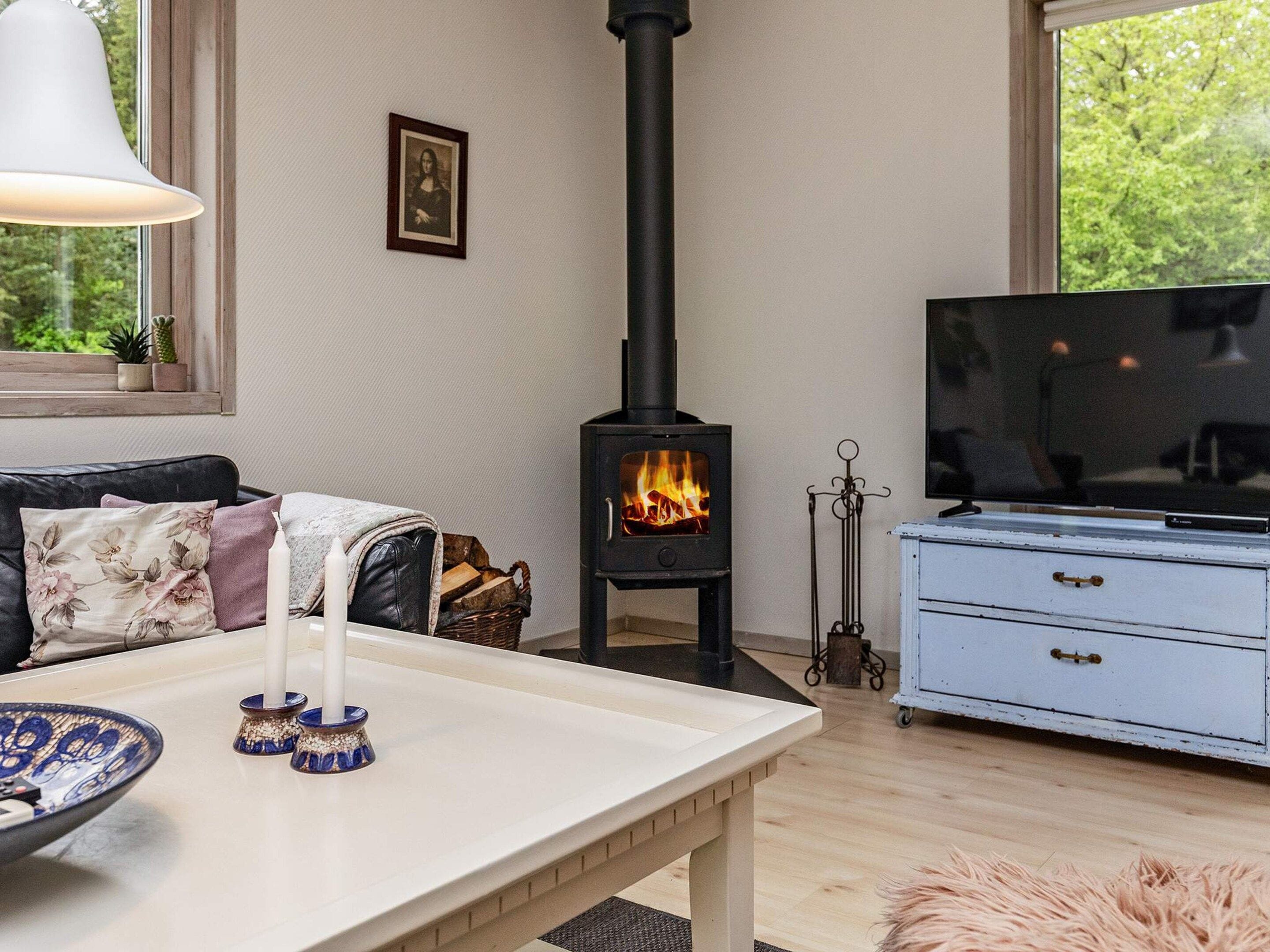 A cozy living room with a fireplace, a television, and a comfortable seating area.