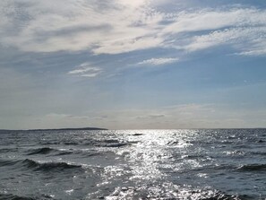 A body of water with sunlight reflecting off the surface.