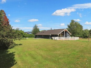 A rural property with a large barn, open grassy fields, and a wooden fence. - 6 Person Holiday Home in Vaeggerlose (Vaeggerlose)