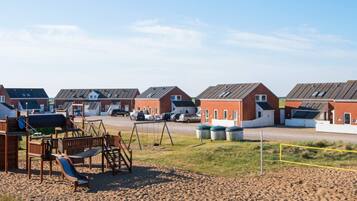 A residential area with multiple houses, a playground, and a parking lot.