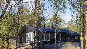 A cabin with a deck and a covered outdoor seating area. - 3 Person Holiday Home in Albaek (Aalbaek)