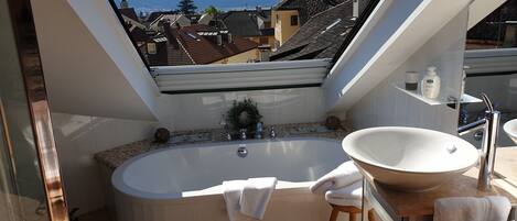 Een bad, een haardroger, badjassen, handdoeken