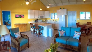 A compact living space with a kitchen, dining area, and seating area. - "Someday Soon" Has Arrived! (St John)