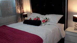 Relax in a stylishly appointed room with a comfortable bed, bedside tables, and ambient lighting.