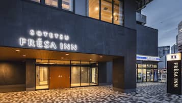 Stylish hotel entrance with a prominent sign and glass door.