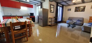 A compact living space with a kitchen, dining area, and seating area.