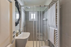 A bathroom with a bathtub, a shower, and a toilet.