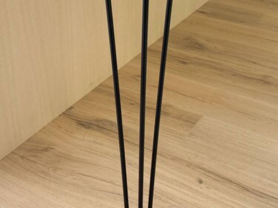 A table with a dark top and three black legs.