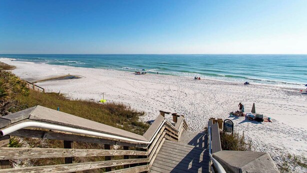 A beach with a wooden boardwalk leading to the water, sandy beach, and clear blue sky. - Seagrove 30A Beach Bungalow with Pool and Hot Tub (Santa Rosa Beach)