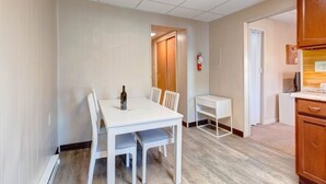 A room with a white table and chairs, a small white desk, and a wooden cabinet. - Candy Bar, Apt #8
One Bedroom with pull out (Hershey)